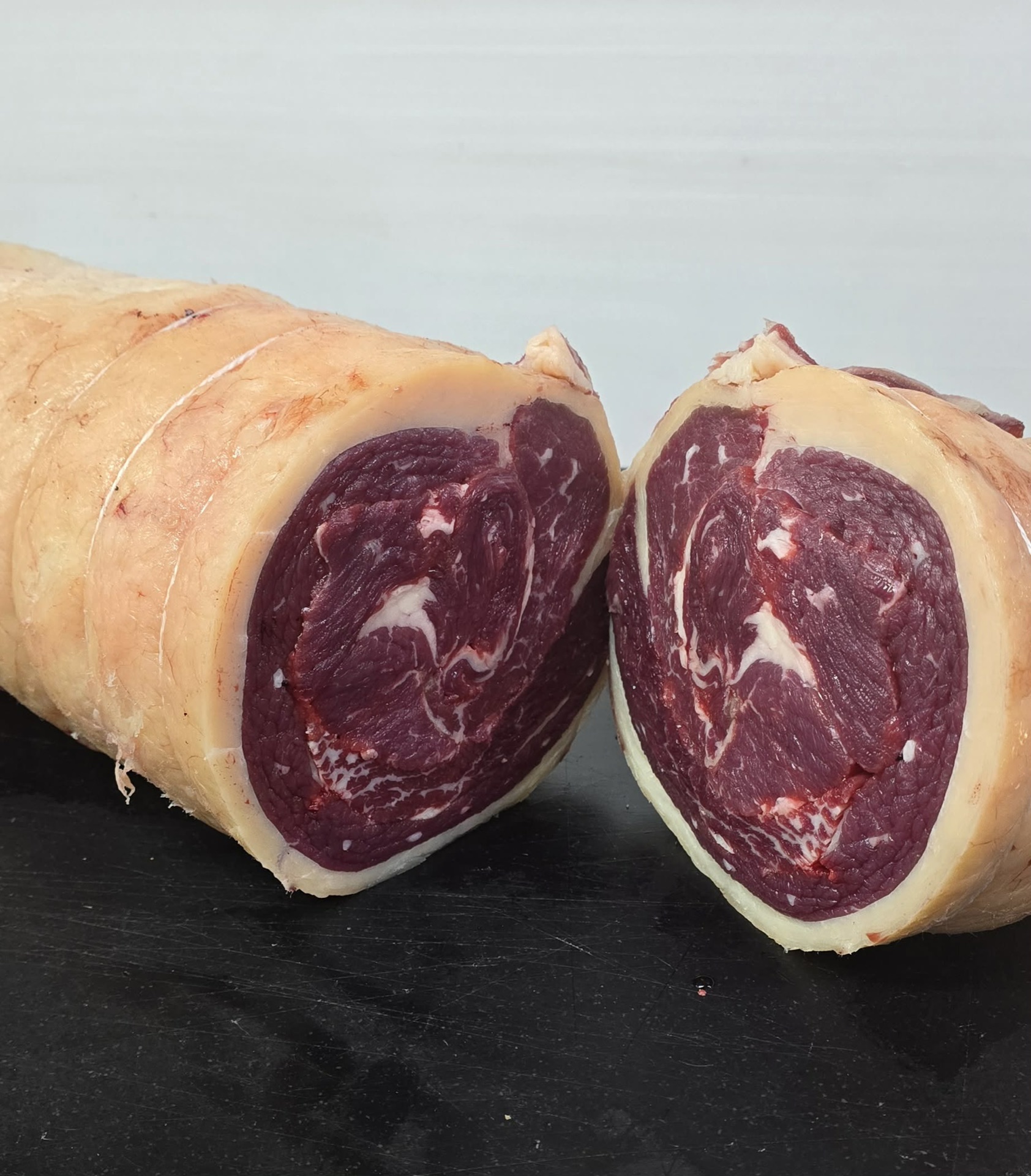 A boned and rolled beef roast cut in half